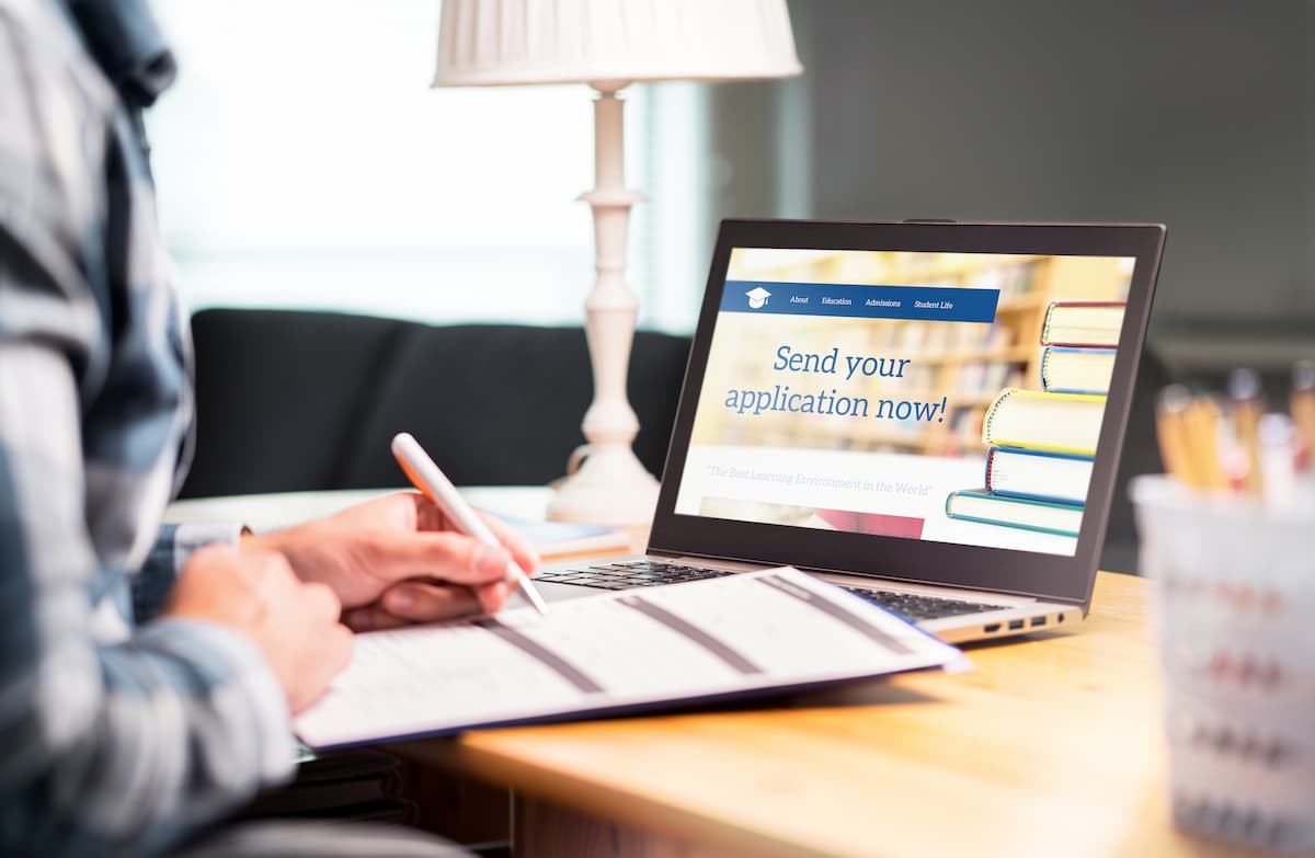 A person on a laptop applying for grants