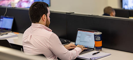 Student working on a laptop in a classroom