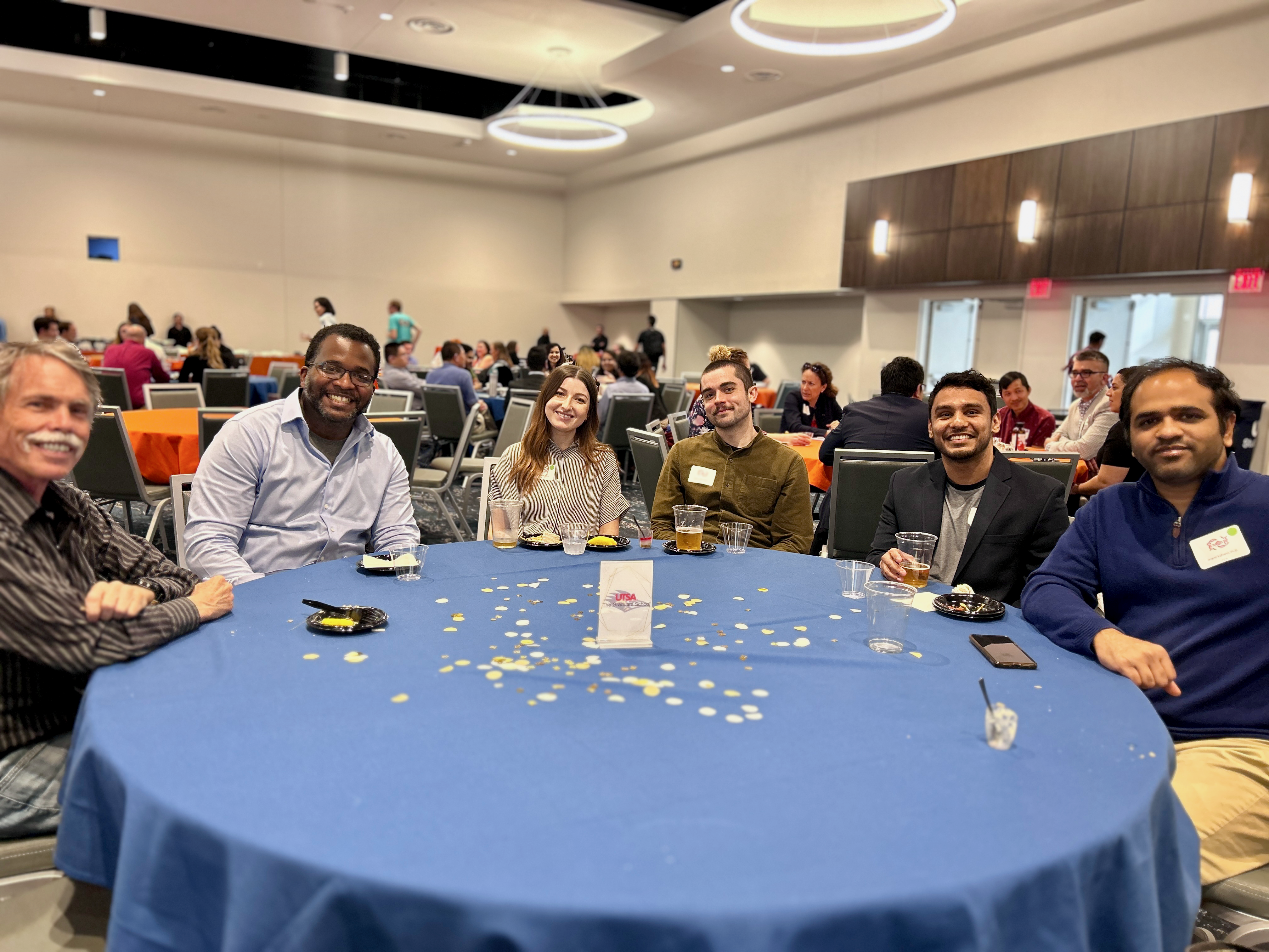 Six people smiling at a table