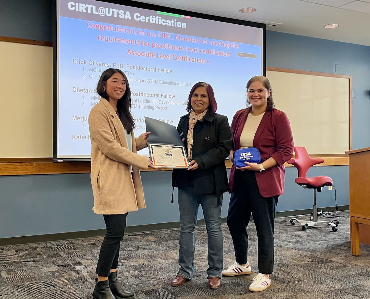 Student receives CIRTL certificate from two Graduate School staff members at recent recognition ceremony